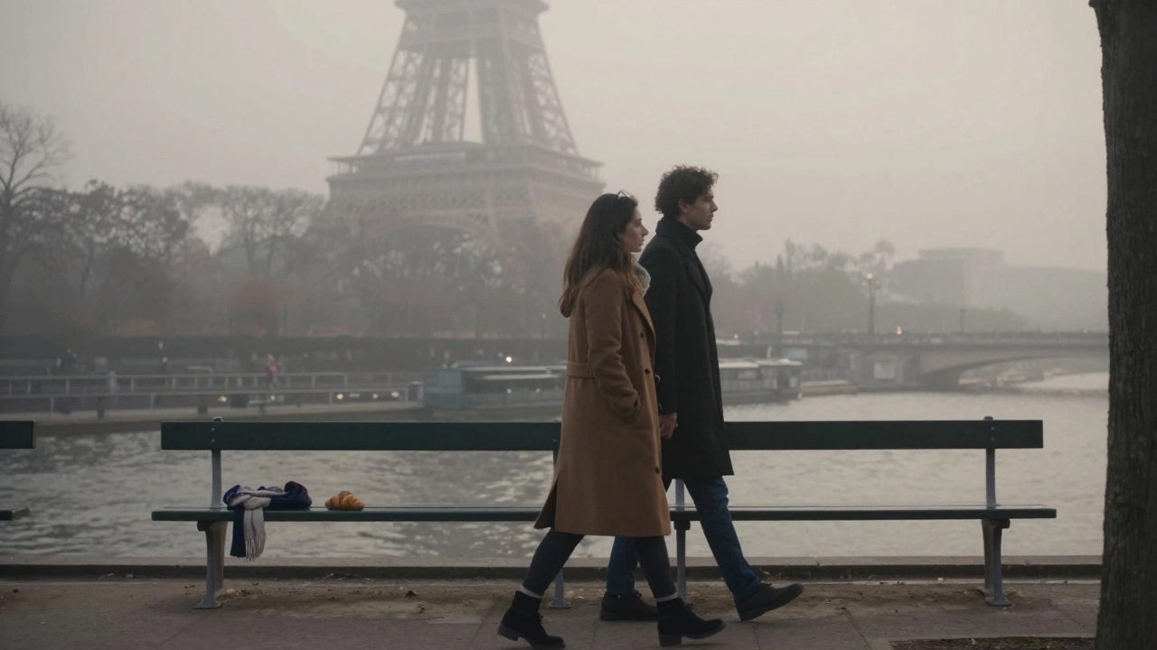 Two people walk slowly through a misty Paris park at dawn, their presence peaceful and unspoken.
